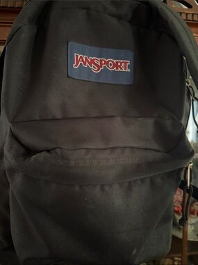 Jansport Black Backpack with Red Logo on Navy Patch